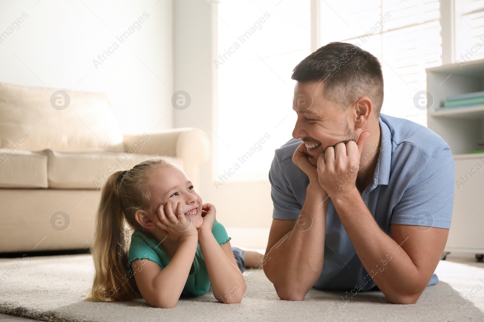 Photo of Dad and daughter spending time together at home. Happy Father's Day