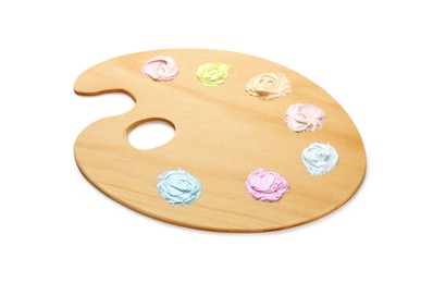 Photo of Wooden artist's palette with samples of pastel paints isolated on white