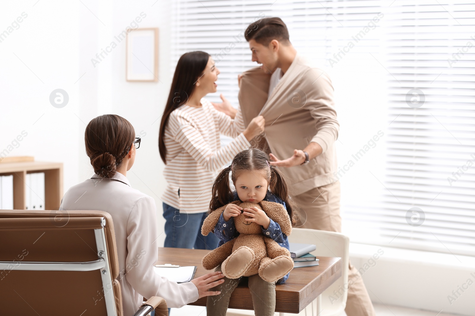 Photo of Professional psychologist working with family in office