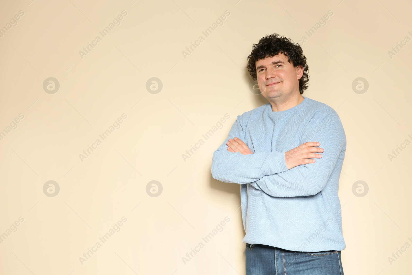 Photo of Portrait of handsome mature man posing on color background. Space for text