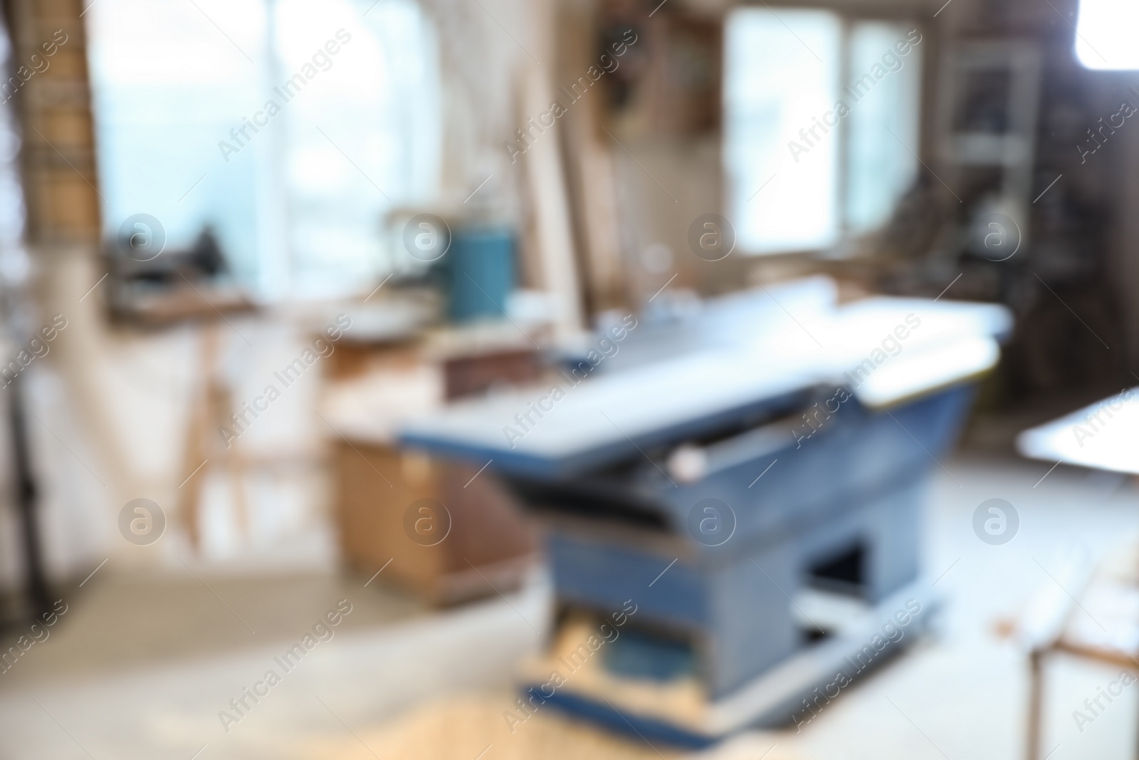 Photo of Blurred view of carpentry shop interior. Working space