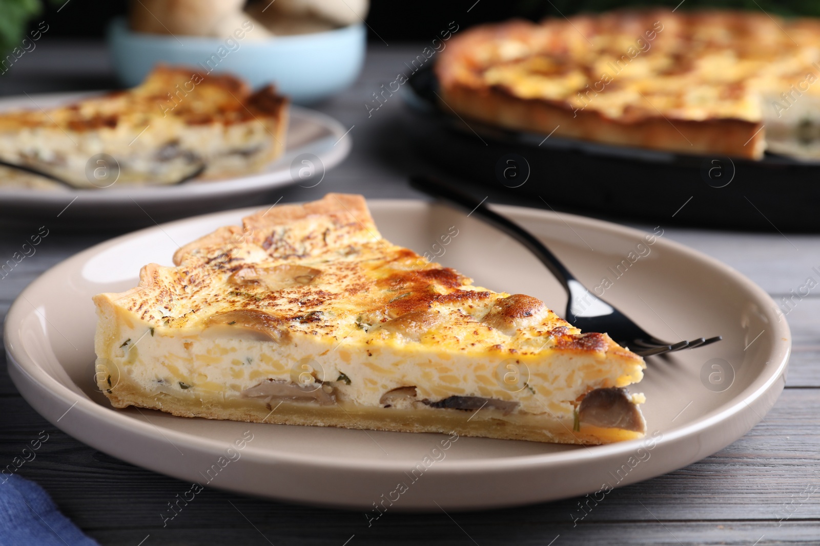 Photo of Delicious pie with mushrooms and cheese served on wooden table, closeup