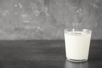 Photo of Glass of milk on table. Fresh dairy product