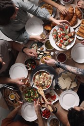 Photo of Group of people having brunch together at table, top view
