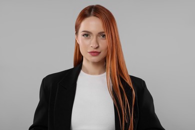 Portrait of beautiful young woman on light gray background