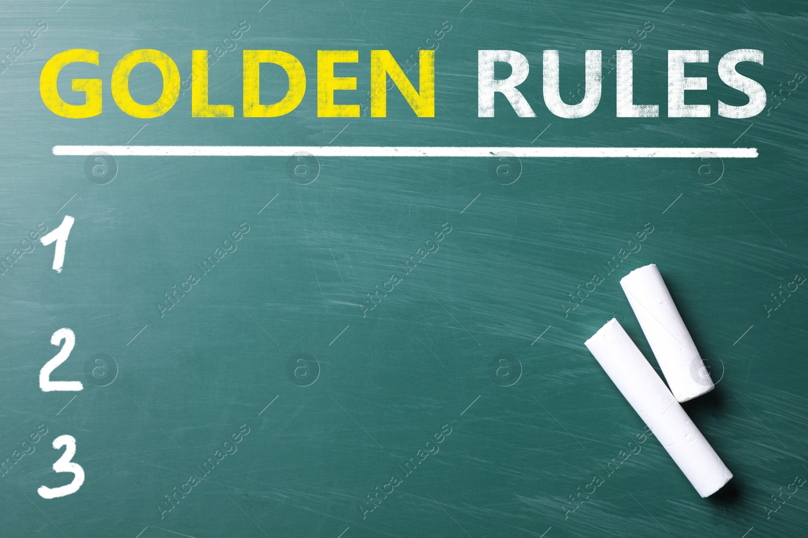 Image of Pieces of white chalk on green chalkboard with phrase GOLDEN RULES, flat lay