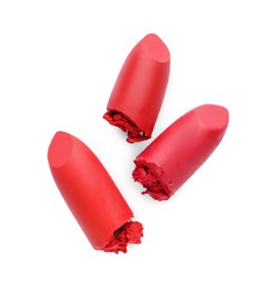 Different beautiful lipsticks on white background, top view