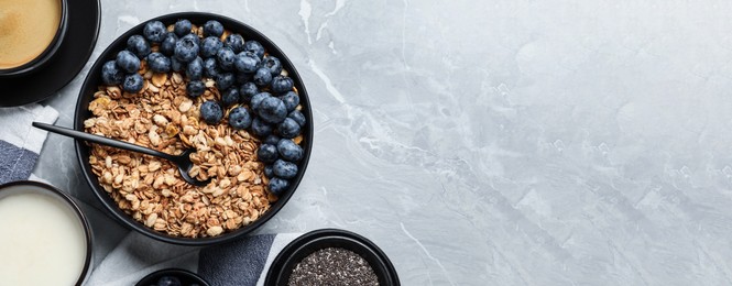 Image of Bowl of oat with blueberries served on light marble table, flat lay with space for text. Banner design