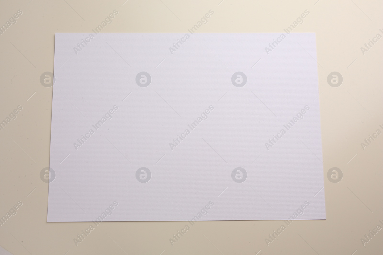 Photo of Sheet of parchment paper on beige background, top view