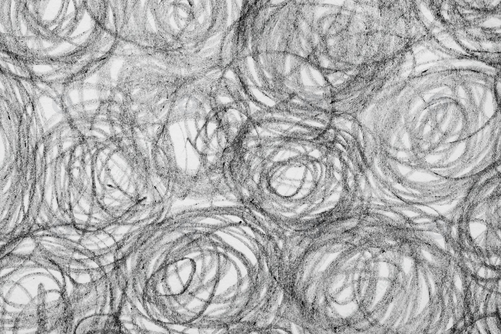 Photo of Circles drawn with pencil on white background, closeup
