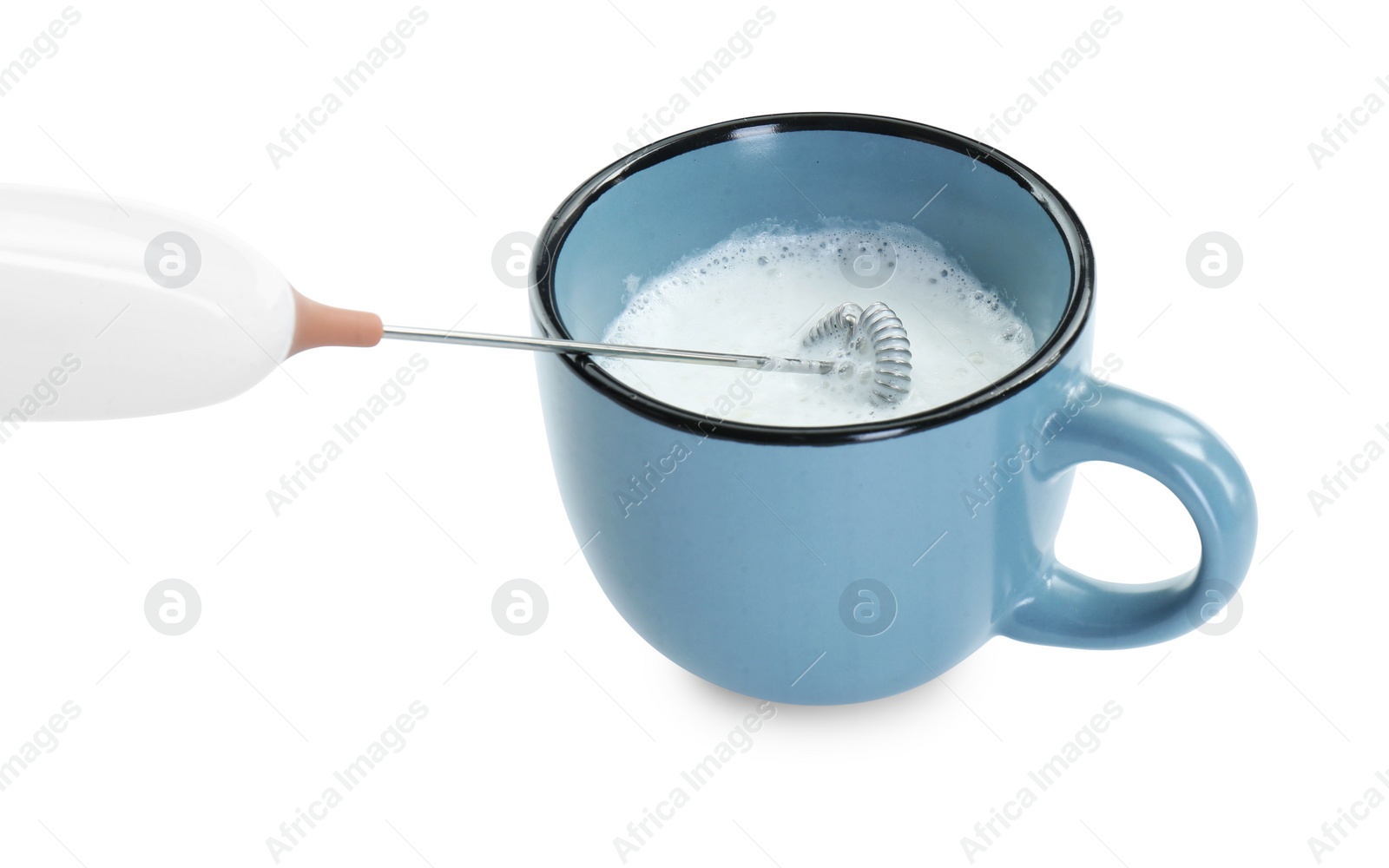 Photo of Whisking milk in cup with mini mixer (frother wand) isolated on white, closeup