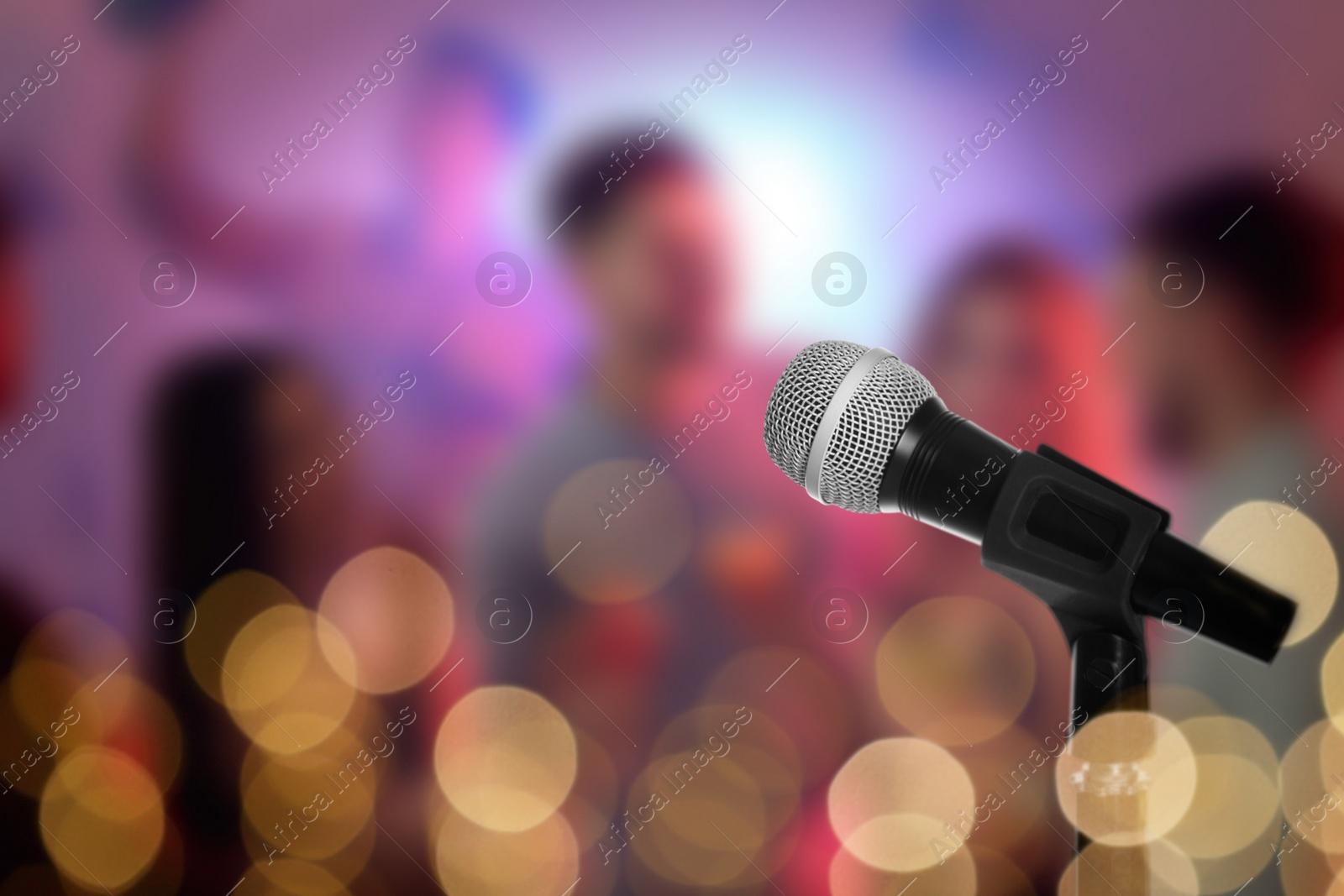 Image of Modern microphone in karaoke club. Space for text