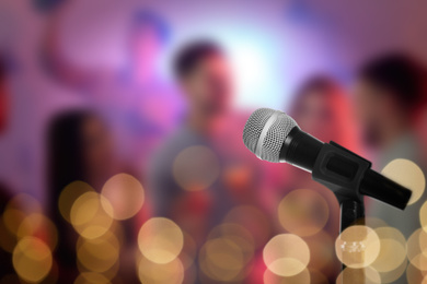 Image of Modern microphone in karaoke club. Space for text