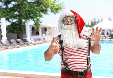 Photo of Authentic Santa Claus with funny glasses at resort