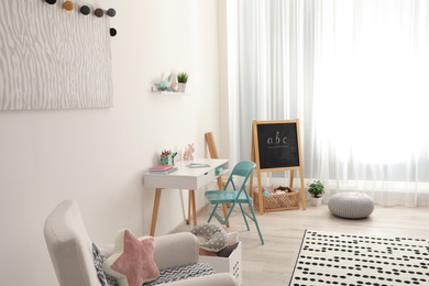 Photo of Modern child room interior with stylish furniture