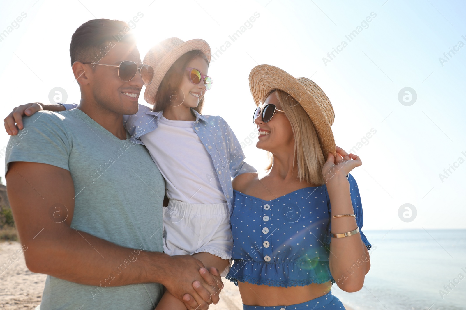 Photo of Happy family at beach on sunny summer day