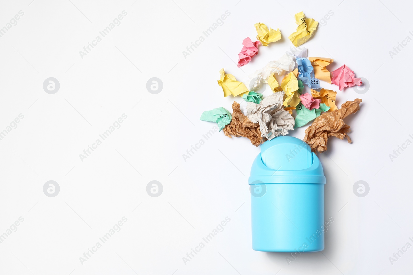 Photo of Trash bin and different garbage isolated on white, top view with space for text. Waste recycling concept