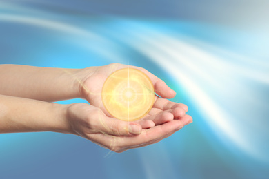Image of Woman holding concentrated healing energy in her hands, closeup