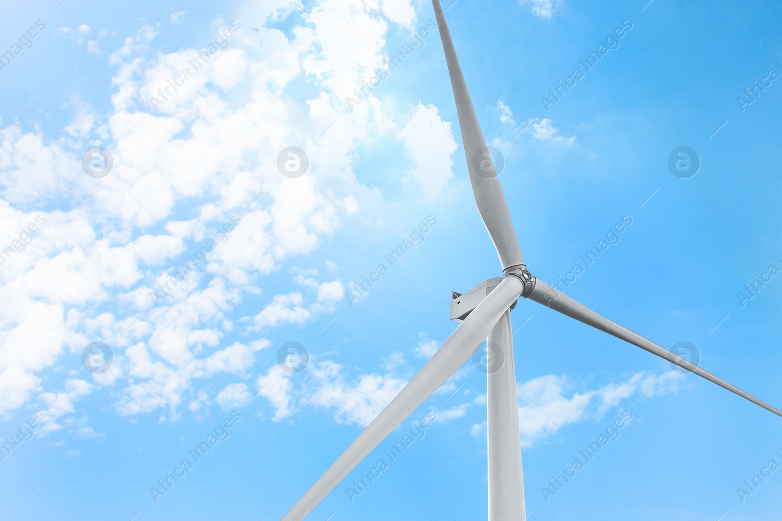 Photo of Modern windmill against sky with clouds, space for text. Energy efficiency