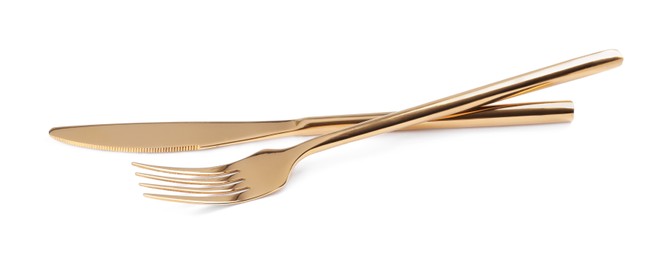 Photo of Golden fork and knife on white background