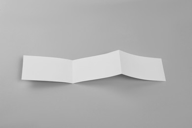 Photo of Blank paper brochure on light grey background. Mockup for design