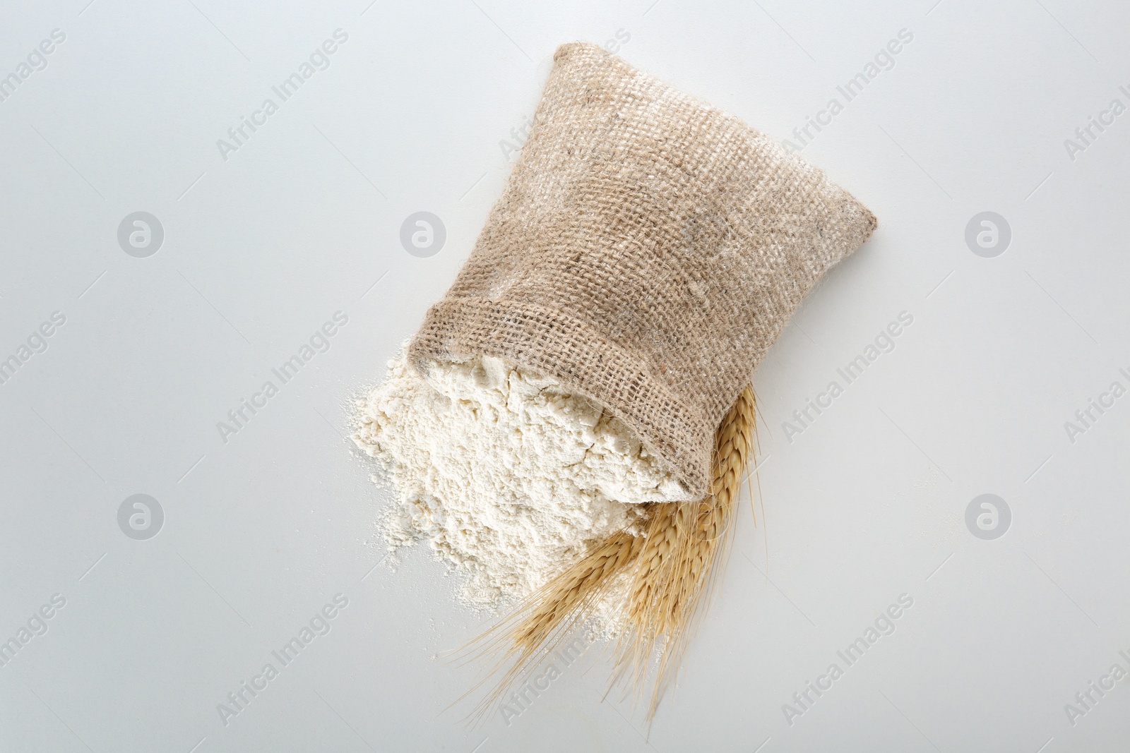 Photo of Sack with flour on white background