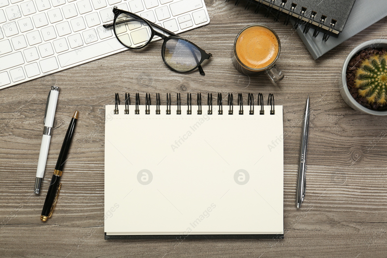 Photo of Flat lay composition with notebooks on wooden table