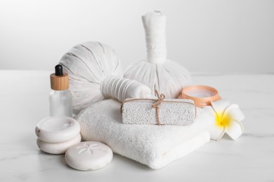 Spa composition with care products on white marble table