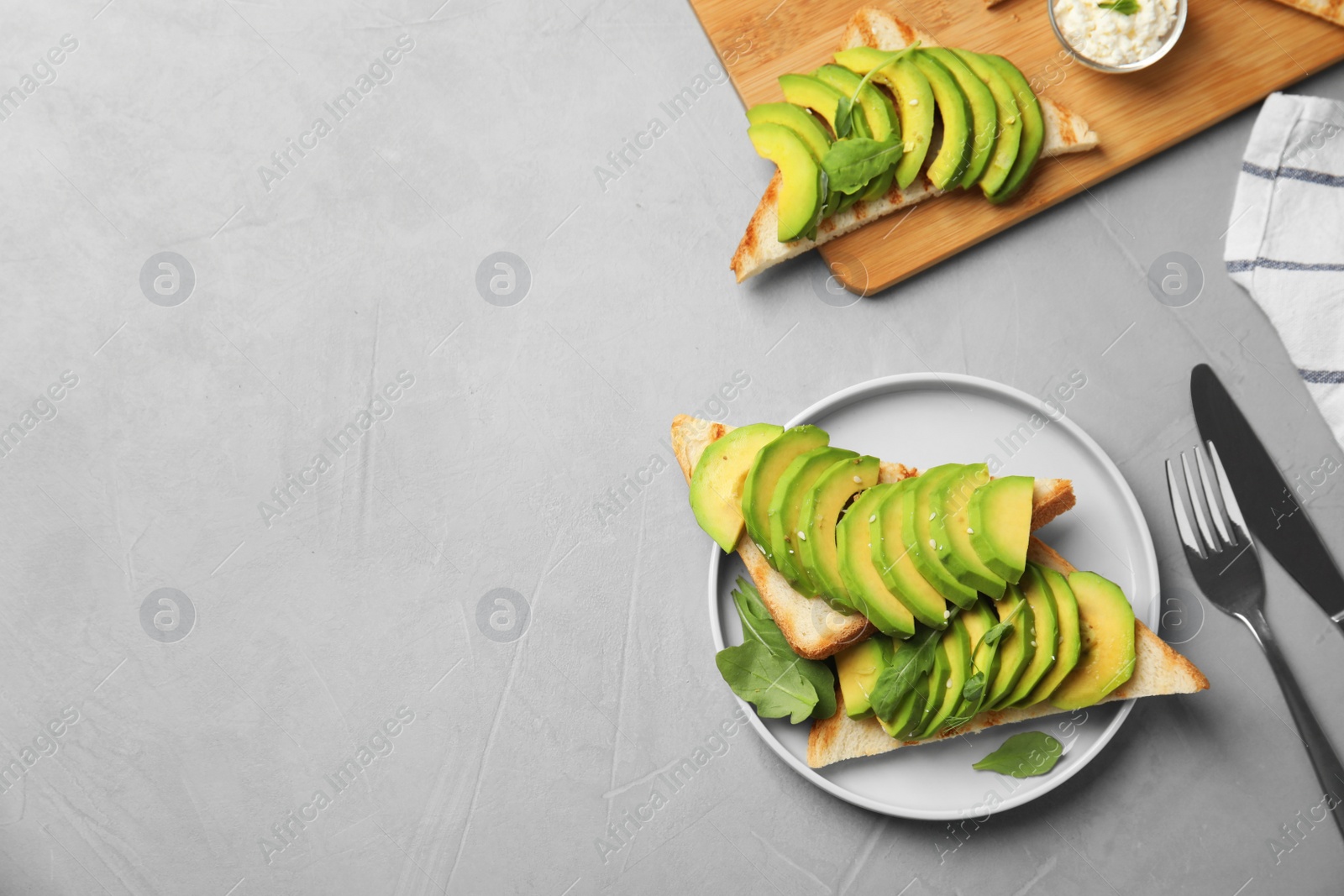 Photo of Flat lay composition with avocado toasts on grey table. Space for text