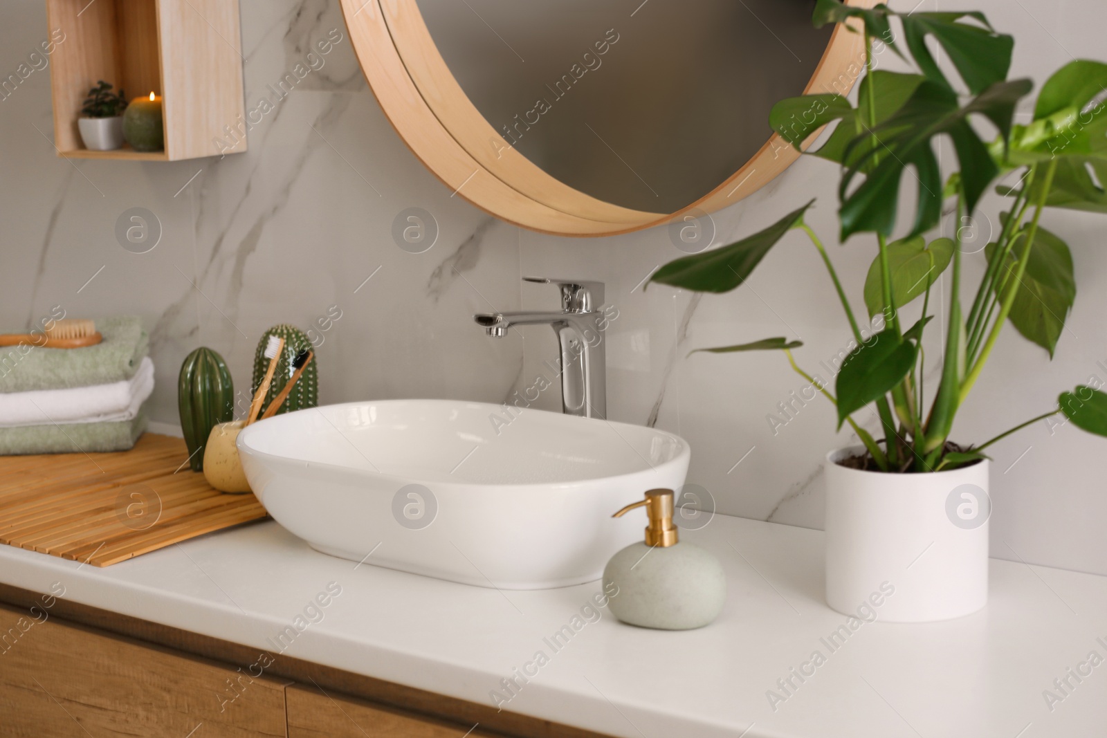 Photo of Stylish vessel sink on light countertop in modern bathroom