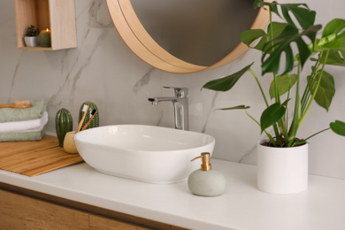 Photo of Stylish vessel sink on light countertop in modern bathroom