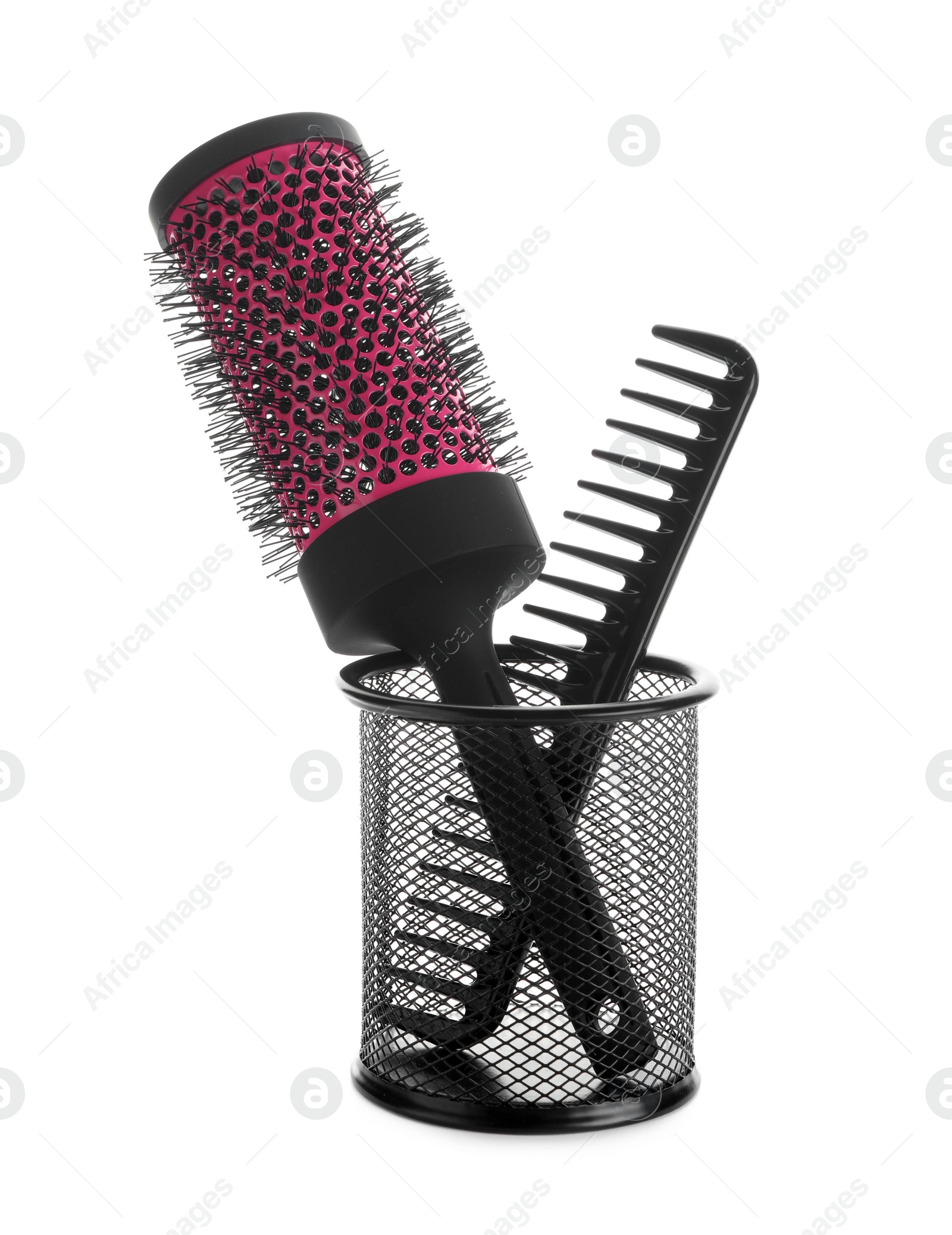 Photo of New modern hair brush and comb in metal holder isolated on white