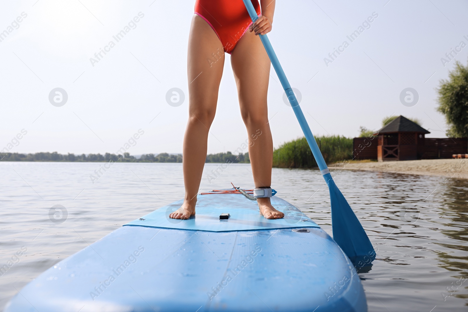 Photo of Woman paddle boarding on SUP board in sea, closeup