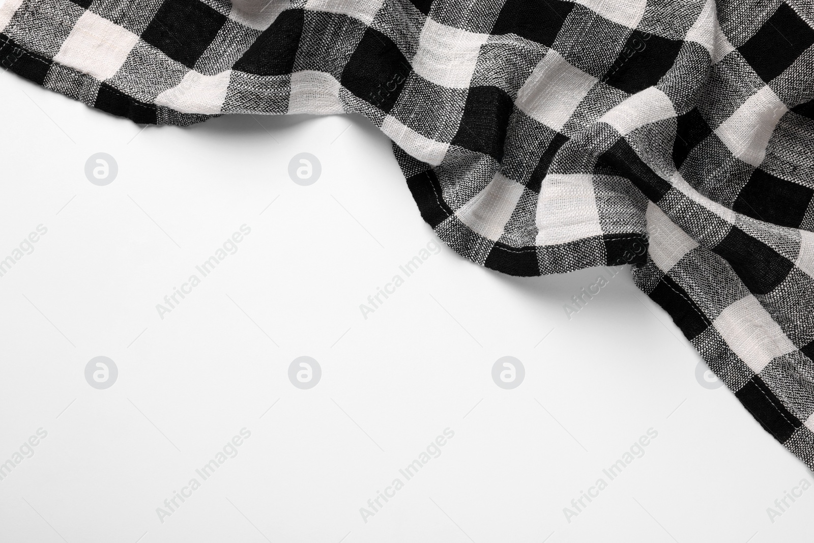 Photo of Black checkered tablecloth on white background, top view