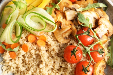 Healthy quinoa salad with vegetables in plate as background