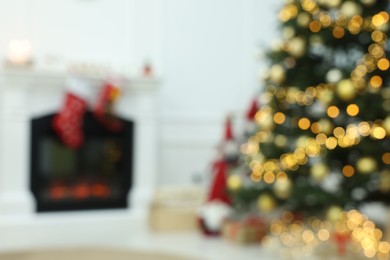 Photo of Blurred view of decorated Christmas tree in living room. Interior design