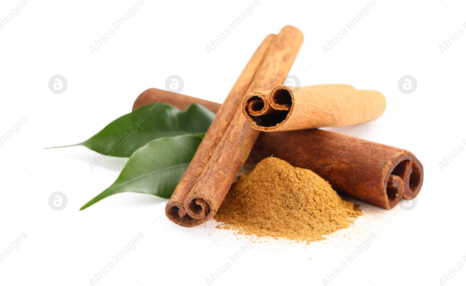 Photo of Dry aromatic cinnamon sticks, powder and green leaves isolated on white