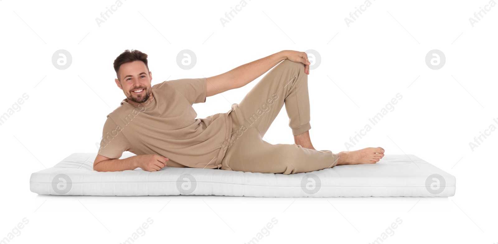 Photo of Man lying on soft mattress against white background