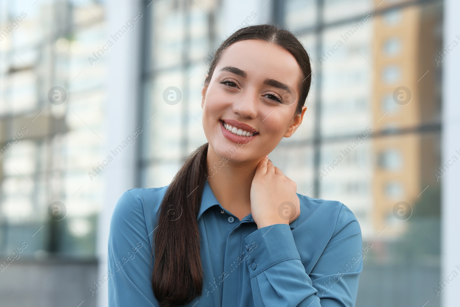 Photo of Portrait of beautiful woman outdoors. Attractive lady smiling and looking into camera