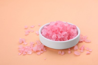 Photo of Plate with pink sea salt on beige background, space for text