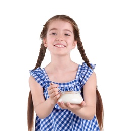 Cute girl eating tasty yogurt on white background