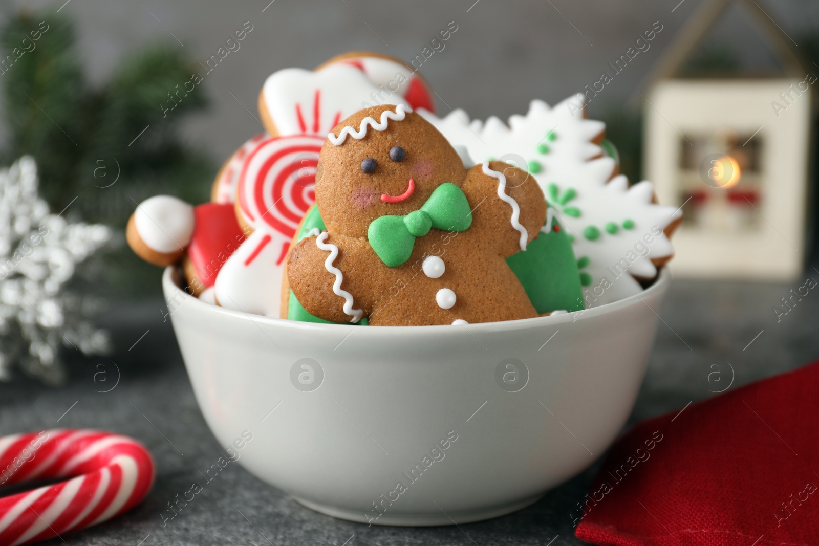 Photo of Delicious Christmas cookies in bowl on grey table