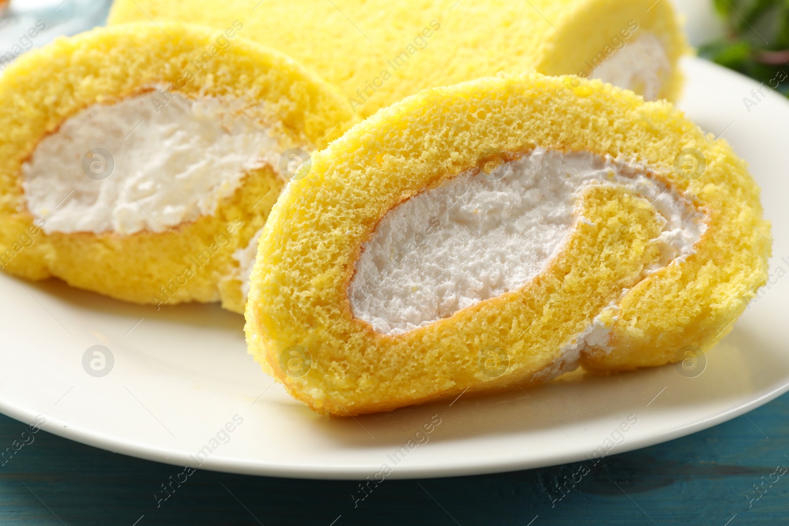 Photo of Pieces of delicious cake roll on table, closeup