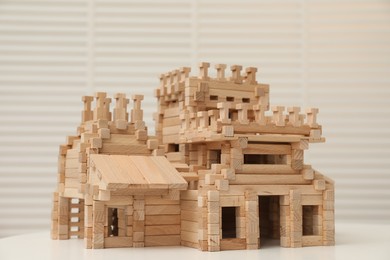 Wooden castle on white table indoors. Children's toy