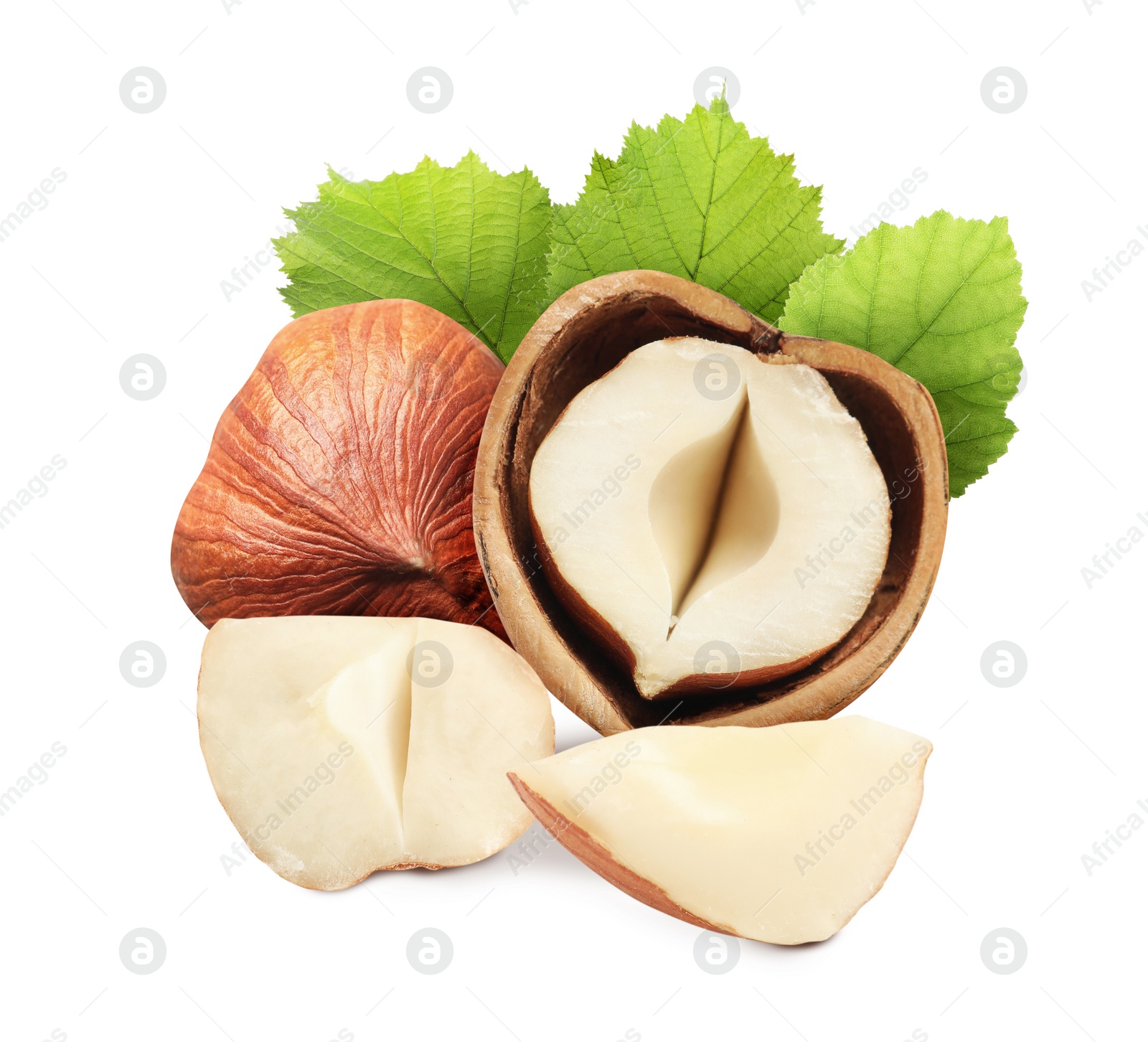 Image of Tasty hazelnuts and green leaves on white background