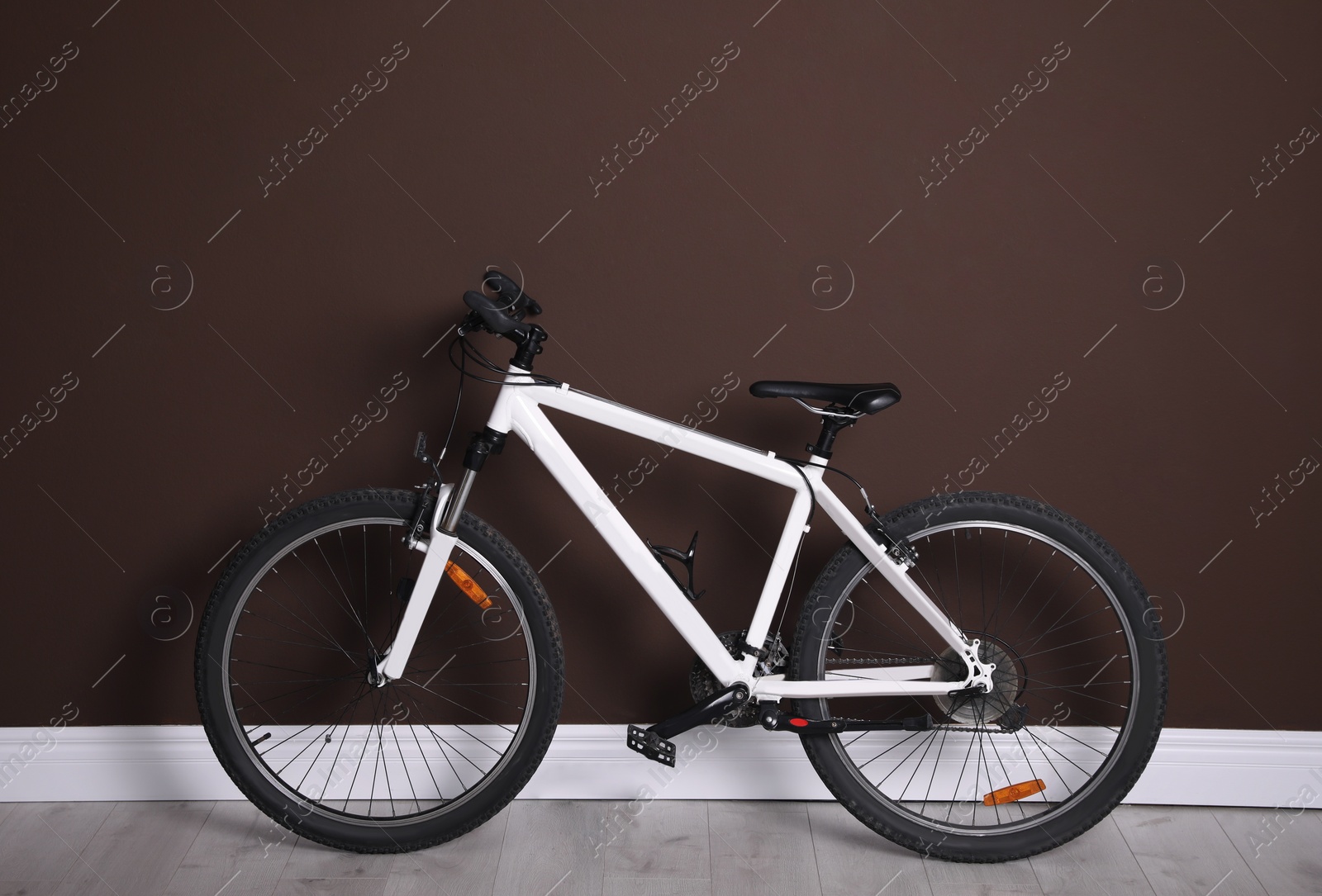 Photo of Modern sport mountain bike near brown wall