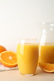 Photo of Glass of orange juice and fresh fruits on wooden table