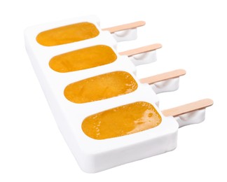 Photo of Tasty orange ice pops in mold isolated on white. Fruit popsicle