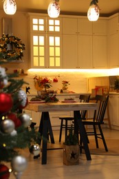 Photo of Cozy dining room decorated for Christmas. Interior design