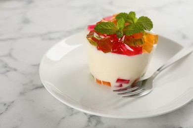 Photo of Delicious broken glass jelly dessert on white marble table, space for text